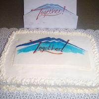 Anniversary Cake A vanilla cake with buttercream frosting to celebrate our church's first year of our together campaign. The logo was hand painted on...