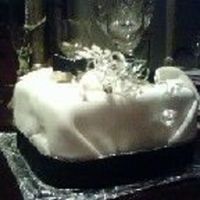 Christmas Present Small square Chocolate Fudge Cake with rolled fondant icing wrapped at the ends like a present. Using a black christmas ribbon trimmed in...