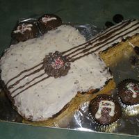 Guitar Cake My father's 44th birthday cake. I didn't have enough frosting, it was a last minute thing. Let's say it looks like wood...