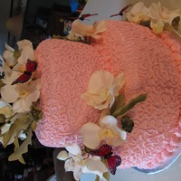 Orchids Orchids and butterflies are artificial. Cake is iced in all buttercream.