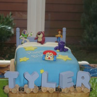 Toy Story Bed Made this for my son's 4th Birthday using inspiration from the galleries. Cake board is a cutting board that I glued pegs on....