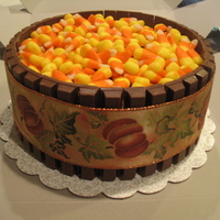 Candy Dish Cake Chocolate cake iced and filled with chocolate icing. Wrapped in Kit Kats and topped with Candy Corn. Idea from the galleries so thanks...
