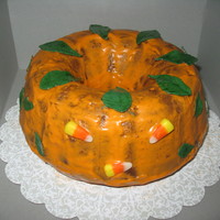 Pumpkin Bundt Cake Pumpkin Chocolate Chip Bundt Cake iced with Cinnamon Cream Cheese Glaze colored orange. Leaves are fondant and painted. From a decoration...