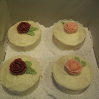 Mini Cakes I did a bunch of mini cakes for my husband's office. They are covered in cream cheese icing with bc roses and leaves.