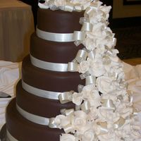Duchess 5 tier wedding cake w/dark chocolate choco-pan fondant and gumpaste roses.Our very first wedding cake !!!!