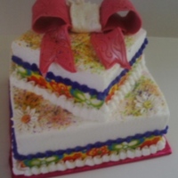 Colorful 4 + 7 inch squares, white cake, BC icing, Fondant Bow, Ribbon. TFL