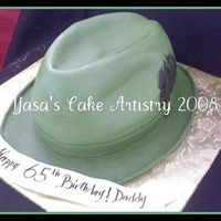 Dobb Hat This was for a 65th birthday for a man who loves hats. Fondant covered with handrawn feathers on side.