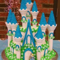 Cinderella's Castle This is a 10" round two layer and a 6" round two layer decorated with buttercream icing. The Dark blue is Royal icing rolled in...