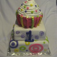 1St Birthday Cupcake Cake! This cake was made for a first birthday party. It was a two tier cake with a huge cupcake on the top for the baby's smash cake! I...