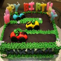 Mikhail Is 2 Vanilla butter cake with buttercream. Model cars and others are gumpaste