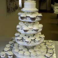 Cupcake Tower Cupcake tower made for a 25th anniversary party. The cupcakes are topped with sparkling sugar and a white chocolate snowflake.