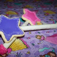 Magic Wands Made these for my daughter. A frosted sugar cookie attached with a ton of white chocolate to a white chocolate dipped pretzel stick.