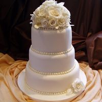 Stacked Ivory Cake With Handmade Cake Topper My second wedding cake. Simple but elegant. The stacking was a nightmare though.