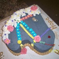 Horse Head Cake Half white, half strawberry cake. Buttercream frosting and candy decorations.