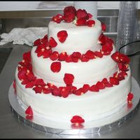 Wedding Cake 3 tier, top & bottom tiers yellow cake, middle tier chocolate. Icing filling in all tiers, with MMF.White ribbon around each tier. Red...
