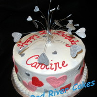 Silver Hearts 10" round with pink, red and silver hearts. Center piece is painted gumpaste. Was hard to do a heart cake with out making it look like...