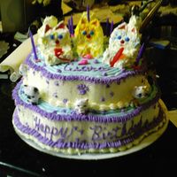 The Cat My Daughter had a cat party. I made this three tier petal pan cake with three little kittens on top and bobble head cats.