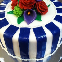 Stripes & Flowers Cake covered in fodant, stripes are fondant, flowers are gumpaste. All painted with luster dust.
