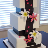 Black And White Square Cake. Black and white square cake with star lily and orchid flowers.