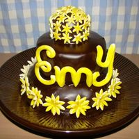 Emy's Cake Bottom layer: Choco chip cake. Middle and Top: Orange and Poppy seed cake. Filled and frosted: Dark Chocolate Ganache. Fondant accents.