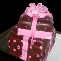 Shower Presents This is a vanilla cake with raspberry filling covered with vanilla and chocolate fondant.