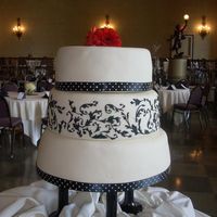 Black And White W/ Red Gerberas This cake is covered in fondant and the design is piped with royal icing to match the wedding invitations. The bride is a graphic artist...
