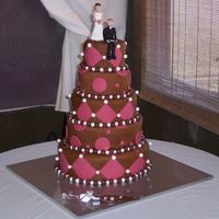 5 Tier Pink And Brown Wedding Cake The cake was white and chocolate. The icing was French vanilla butter cream. Covered with fondant. The white balls are fondant and the...