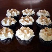 Heathbar Cupcake chocolate cake with heathbar candy baked in. topping is chocolate ganache with cream cheese frosting and heathbar brickle on top