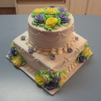 Purple/yellow Shower Cake 2 layer 8" square cake and 2 layer 6" round, chocolate and French vanilla layers, iced in all buttercream.