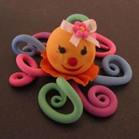 Happy Octopus! Fondant covered body. Fondant legs. Painted eyes. Fondant, fondant and more fondant and lots of coloring!