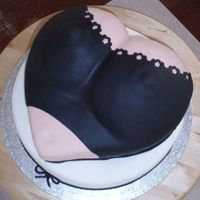 Black Bra Black bra / corsage on white base cake. Chocolate cake w/ raspberry filling.Please let me know if I should put it in the 'naughty'...