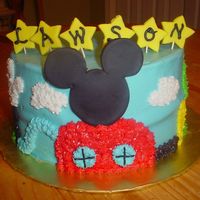 Mickey Mouse Clubhouse Two-layer white cake with buttercream icing and detail. Mickey's head on the clubhouse is made from fondant, as well as the stars on...