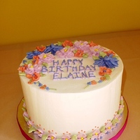 Happy Birthday Elaine Non-crusting buttercream icing with various flower decorations. Pink, Coral, Blue/Purple color scheme