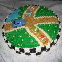 Cars Cake Cake with lemon cream and straberry jelly, decorated with royal icing, colored sugar, withe chocolate balls and car candies