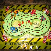 Happy 8Day The cars on the cake board are chocolate cars.