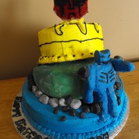 Transformers Chocolate cake with mud filling ... Transformers make out of RKT covered in Modeling Chocolate , logos and rocks are also Modeling...