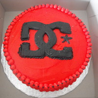 Dc Logo Cake Vanilla cake with vanilla buttercream filling , covered in buttercream with MMF Logo