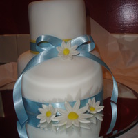 Daisy Anniversary Cake I made this cake for my parents anniversary. WASC with buttercream and covered in MMF. The daisies are MMF/gumpaste. TFL!