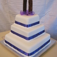 3 Tier Wedding Cake Chocolate cake top and bottom with banana cake to middle tier. 3 tiers with fondant icing, choc shards and deep purple ribbon for...
