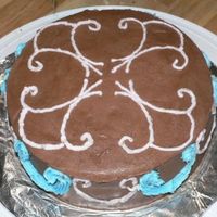 Chocolate With Scrolls Wilton class I, first cake done. Chocolate buttercream with scrolls in pink and blue.