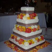 Scrollwork With Flowers 4 tiers, all buttercream, pillared with flowers in between. I think the florist did a great job with the flowers! The border was made of...