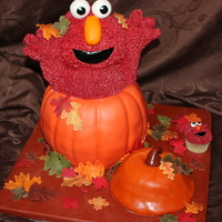 Elmo Pumpkin made of pumpkin spice cake filled with cream cheese, pumpkin top made of cinnamon roll cake both covered in buttercream and fondant...