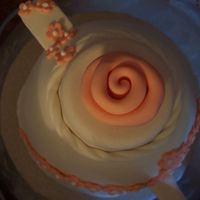 Peach Fondant Ribbon Rose A close up of the fondant ribbon rose on top of the peach teapot cake.