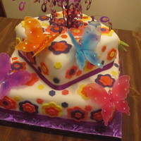 Birthday Cake Cake is covered with fondant flowers. Butterflies are not edible.