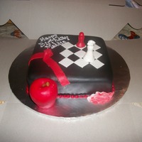 Twilight Cake 8" square cake covered in black MMF, rice crispie apple, and MMF chess pieces!