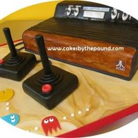 Atari 2600 Cake This lovely game console is completely edible. It is all cake covered in fondant. The Joysticks are cake with poured chocolate handles...