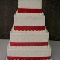 Dots And Ribbon This is a stacked cake with cloth ribbon with no wire and the dots and icing is mad out of all butter cream.