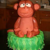Monkey Cake Monkey is rice krispie treats covered fondant.Cake is yellow, covered in chocolate bc with green fondant leaves on top