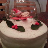 Snowglob_1.jpg The cake is covered in BC. The baby is gumpaste. The globe is a bowl turned upside down