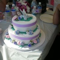 Fairy Baby Shower Cake fondant covered double tiered round cake. gumpaste mushrooms and flowers. I made this for my sister's fairy themed baby shower. thanks...